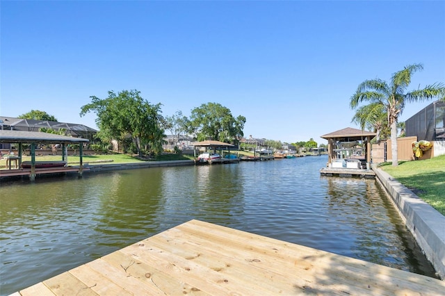 view of dock featuring a gazebo and a water view