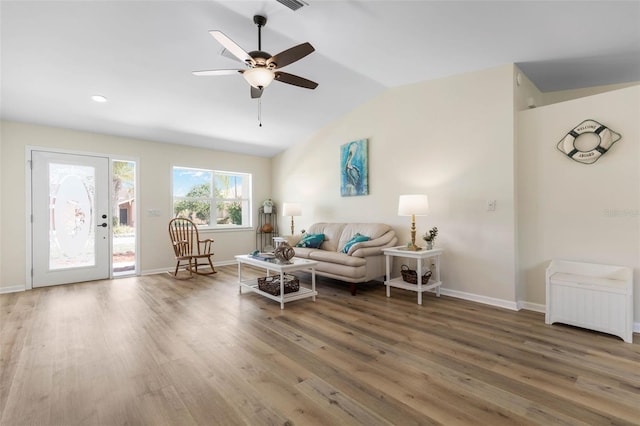 living room with wood-type flooring, ceiling fan, and lofted ceiling