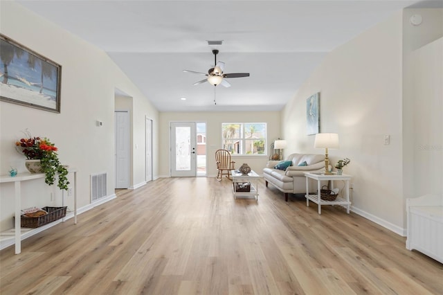 living room with light wood-type flooring, vaulted ceiling, and ceiling fan