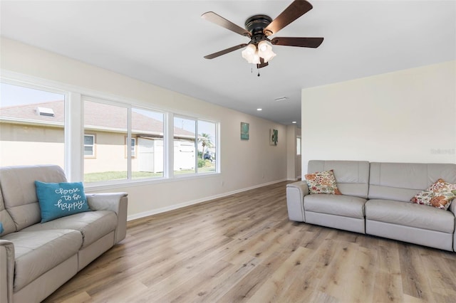 living room with light hardwood / wood-style floors and ceiling fan