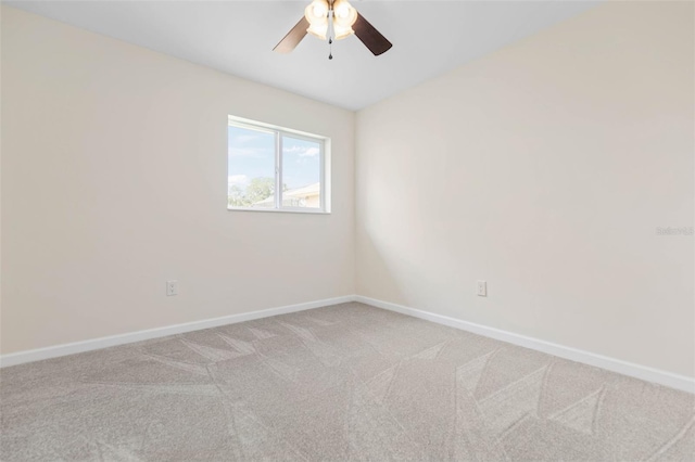 empty room featuring carpet flooring and ceiling fan