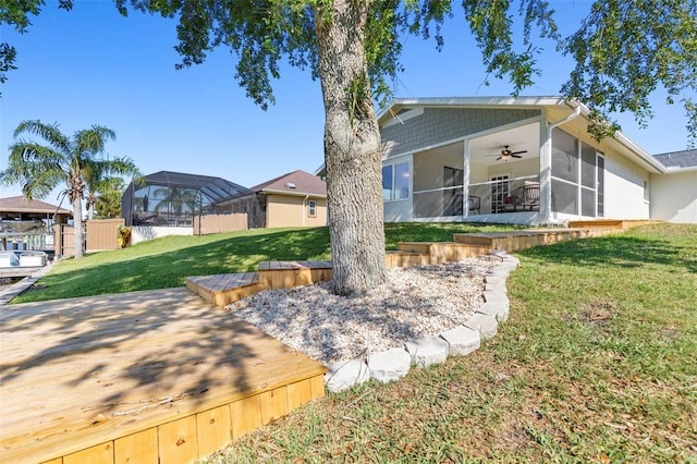 view of yard featuring a deck and a sunroom