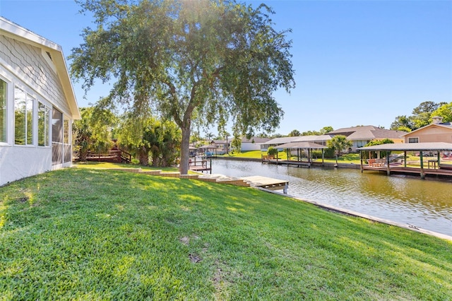 view of yard featuring a boat dock and a water view