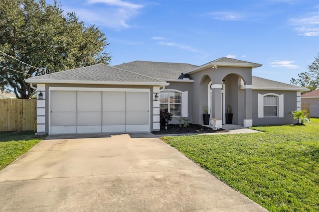 view of front of property featuring a front lawn and a garage