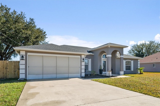 single story home with a garage and a front lawn