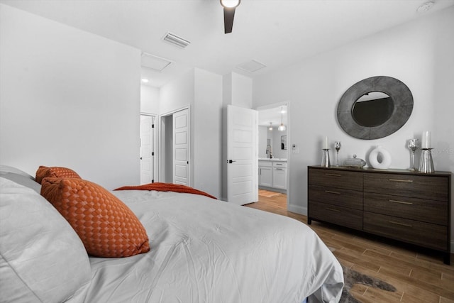 bedroom with ceiling fan, sink, and ensuite bathroom