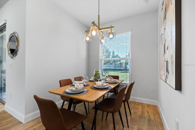 dining space featuring a chandelier and light hardwood / wood-style floors