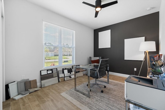 home office with ceiling fan and light wood-type flooring