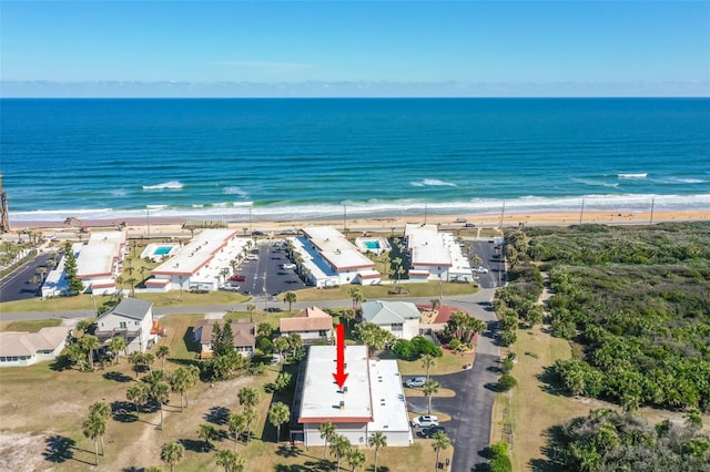 bird's eye view featuring a water view and a view of the beach