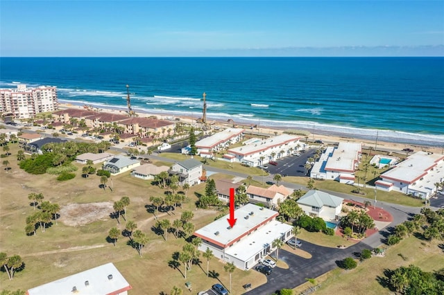 drone / aerial view with a water view and a beach view