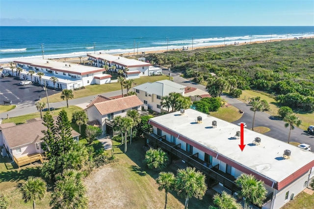 birds eye view of property with a water view and a view of the beach