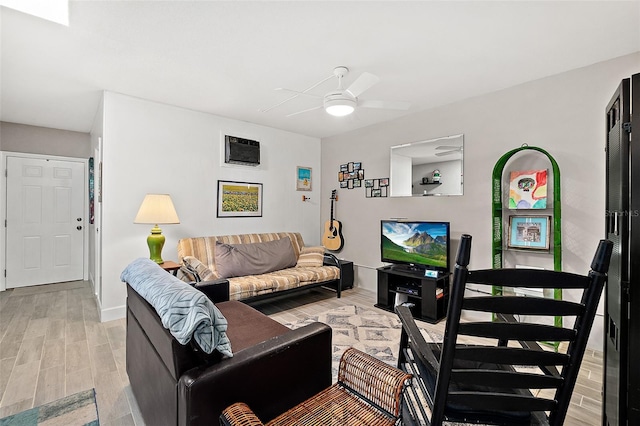 living room featuring ceiling fan and light hardwood / wood-style floors