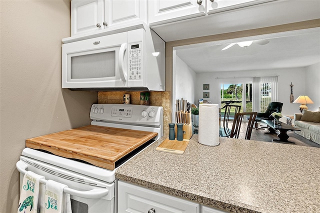 kitchen featuring white cabinets and white appliances