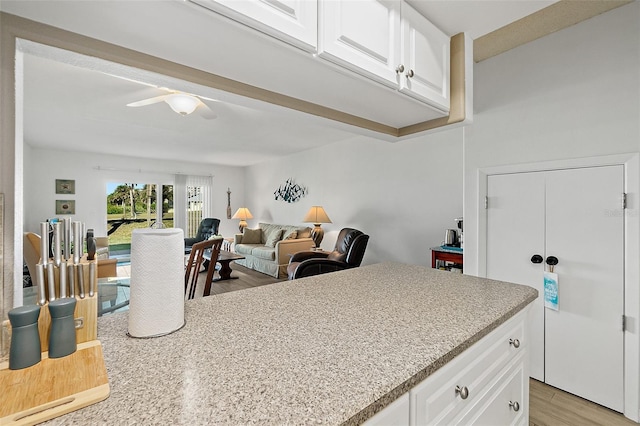 kitchen featuring light hardwood / wood-style floors, white cabinetry, and ceiling fan