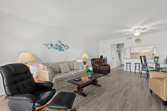 living room featuring light hardwood / wood-style floors and ceiling fan