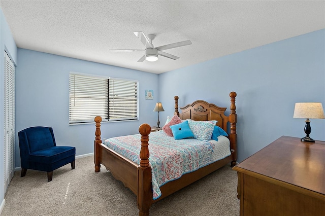 carpeted bedroom featuring ceiling fan, a closet, and a textured ceiling