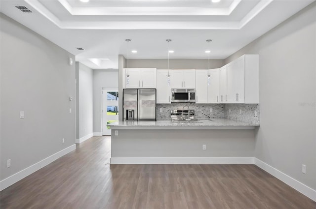 kitchen featuring sink, white cabinetry, light stone counters, kitchen peninsula, and stainless steel appliances