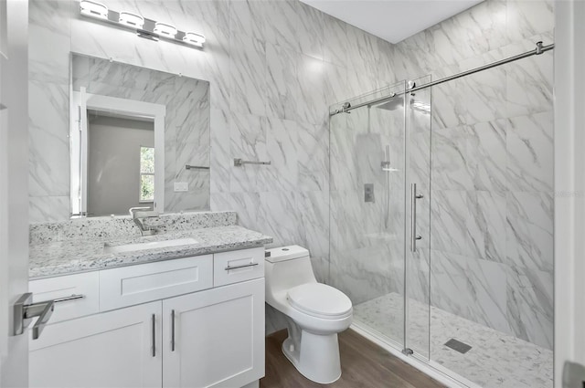 bathroom featuring hardwood / wood-style floors, vanity, toilet, tile walls, and an enclosed shower