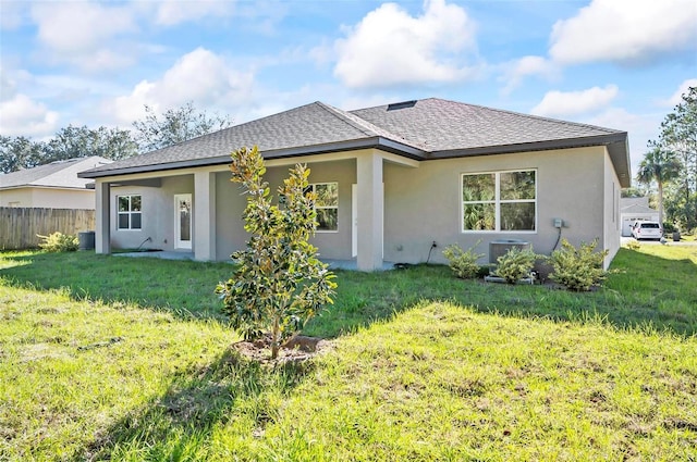 rear view of house featuring a lawn