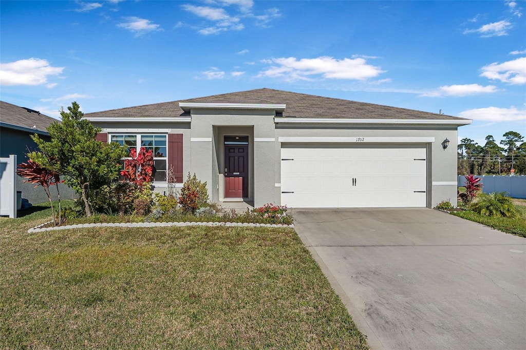 view of front of house with a garage and a front yard