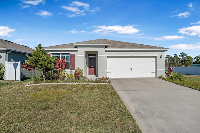 view of front of property featuring a garage and a front lawn