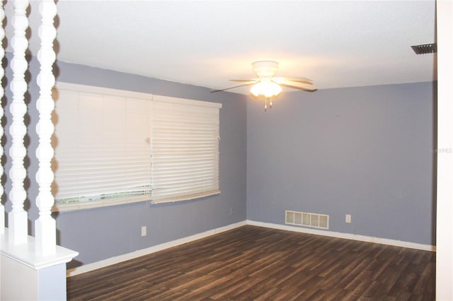 empty room with ceiling fan and dark hardwood / wood-style floors