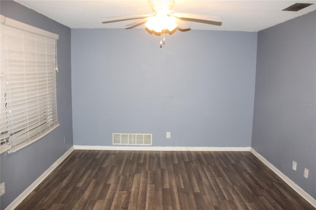 unfurnished room featuring ceiling fan and dark wood-type flooring