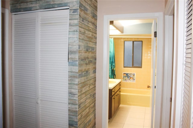 bathroom with tile patterned flooring, vanity, and a washtub