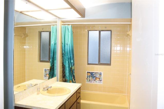 bathroom with shower / tub combo with curtain and vanity