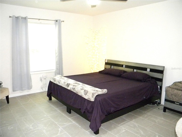 bedroom featuring ceiling fan and multiple windows