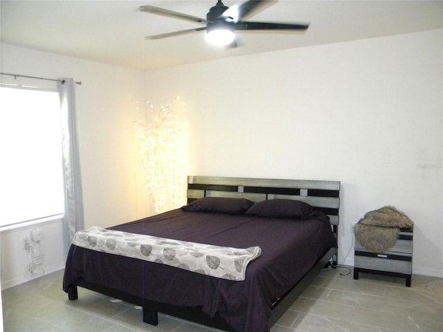 bedroom with ceiling fan and multiple windows