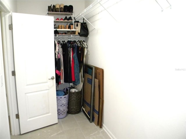 spacious closet with light tile patterned floors