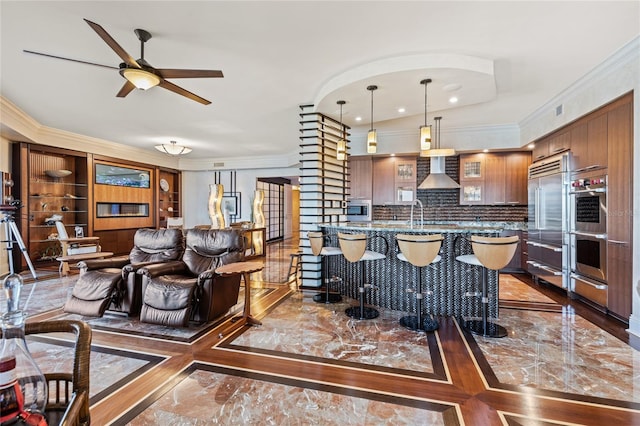 living room with ceiling fan, crown molding, and vaulted ceiling