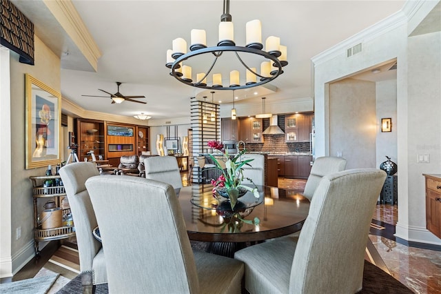 dining area featuring ceiling fan with notable chandelier and ornamental molding