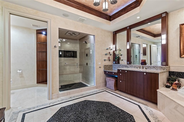 bathroom with vanity, a raised ceiling, a shower with door, and ornamental molding