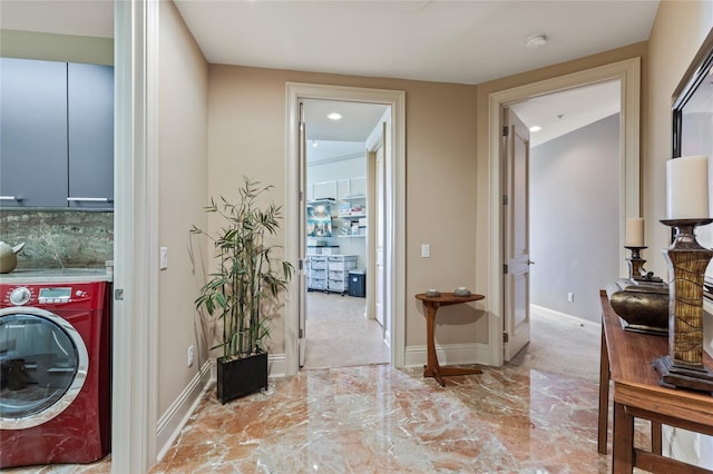 laundry room with cabinets and washer / dryer