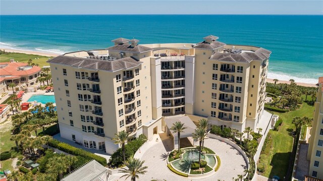 birds eye view of property featuring a view of the beach and a water view