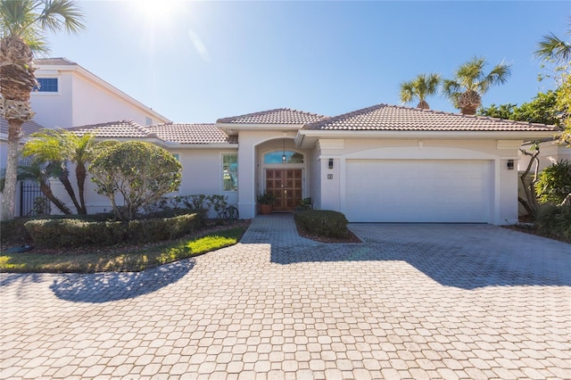 mediterranean / spanish-style home featuring a garage