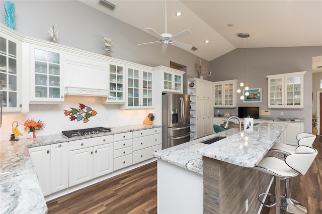 kitchen featuring sink, hanging light fixtures, tasteful backsplash, stainless steel fridge with ice dispenser, and white cabinets