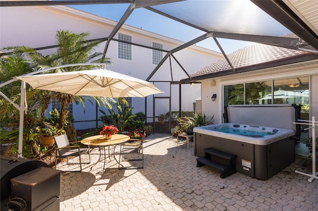 view of patio featuring glass enclosure, a hot tub, and a grill