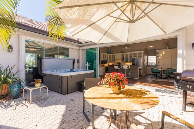 view of patio featuring a hot tub and a deck