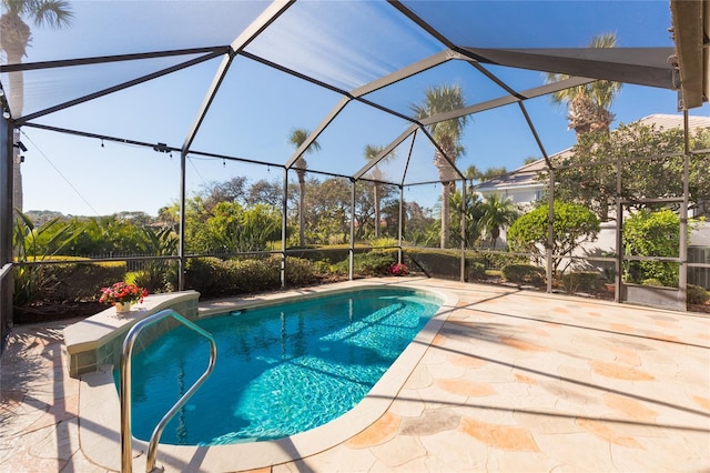 view of swimming pool with glass enclosure and a patio