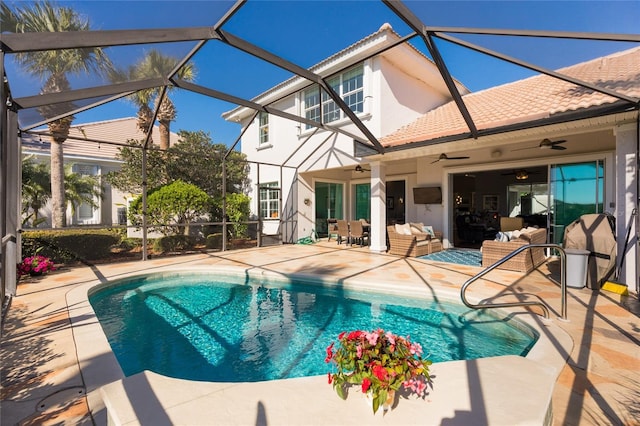 view of pool with a lanai, ceiling fan, and a patio area