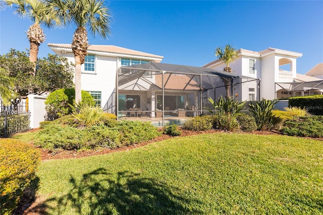 back of property featuring a yard, a pool, and a lanai