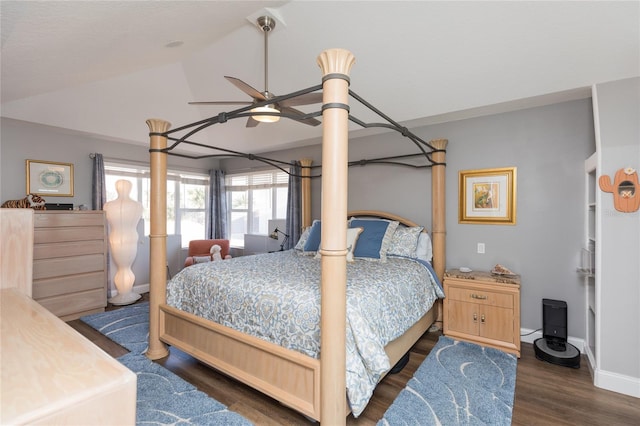 bedroom with ceiling fan, dark hardwood / wood-style floors, and lofted ceiling