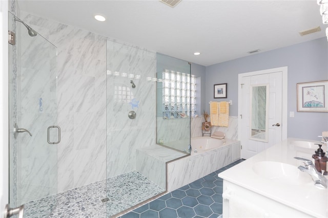 bathroom with tile patterned floors, vanity, and separate shower and tub