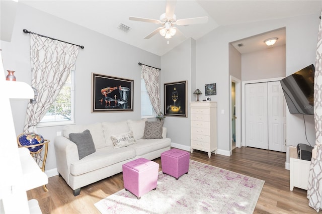 living room featuring ceiling fan, vaulted ceiling, and hardwood / wood-style flooring