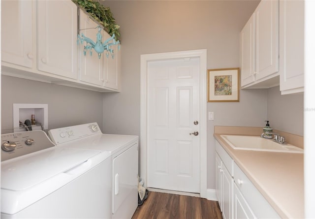 clothes washing area with sink, cabinets, dark hardwood / wood-style floors, and independent washer and dryer