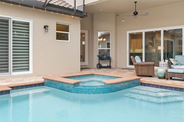 view of swimming pool with an in ground hot tub and ceiling fan