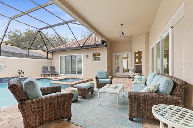 view of patio / terrace with outdoor lounge area, french doors, a lanai, and a pool with hot tub